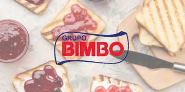 Vemos una imagen del logo de la empresa Bimbo con una imagen detrás de unas tostadas de su pan de molde característico.