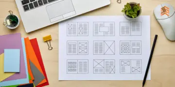 Vemos una imagen de un layout de una empresa sobre un escritorio con papeles y una computadora.