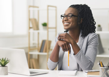 En la imagen se ve una mujer trabajando con una computadora